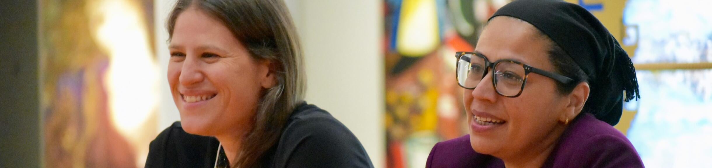Two women speaking at a panel