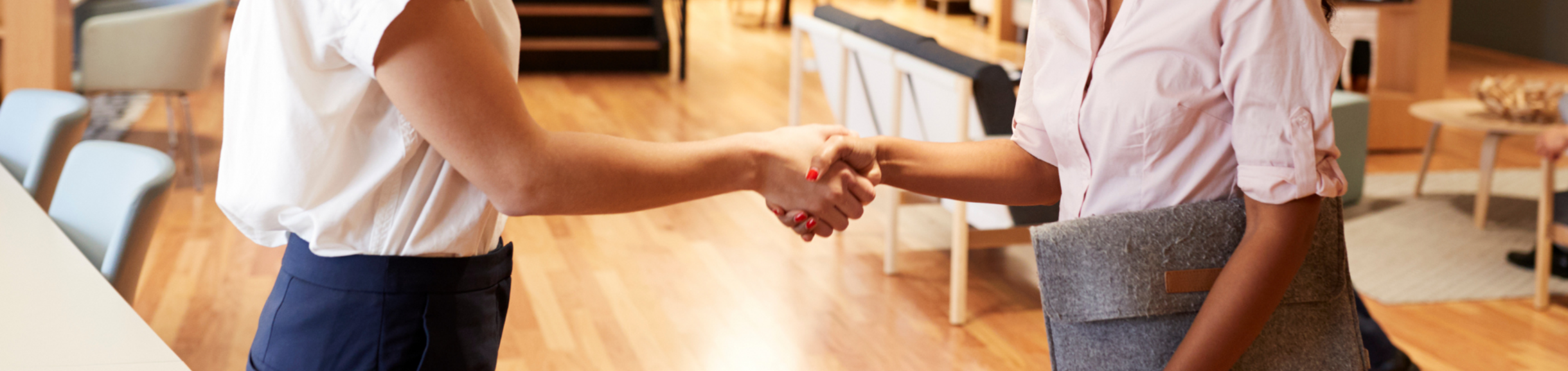 Two women shaking hands