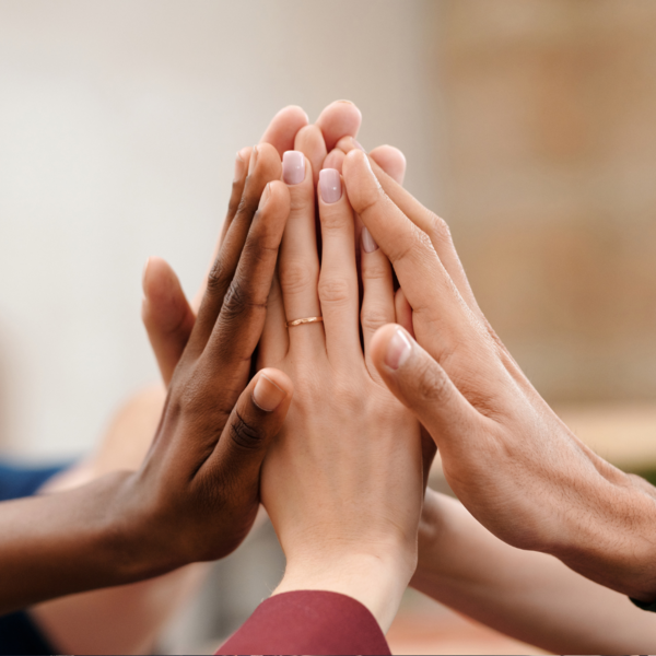 People with their hands stacked